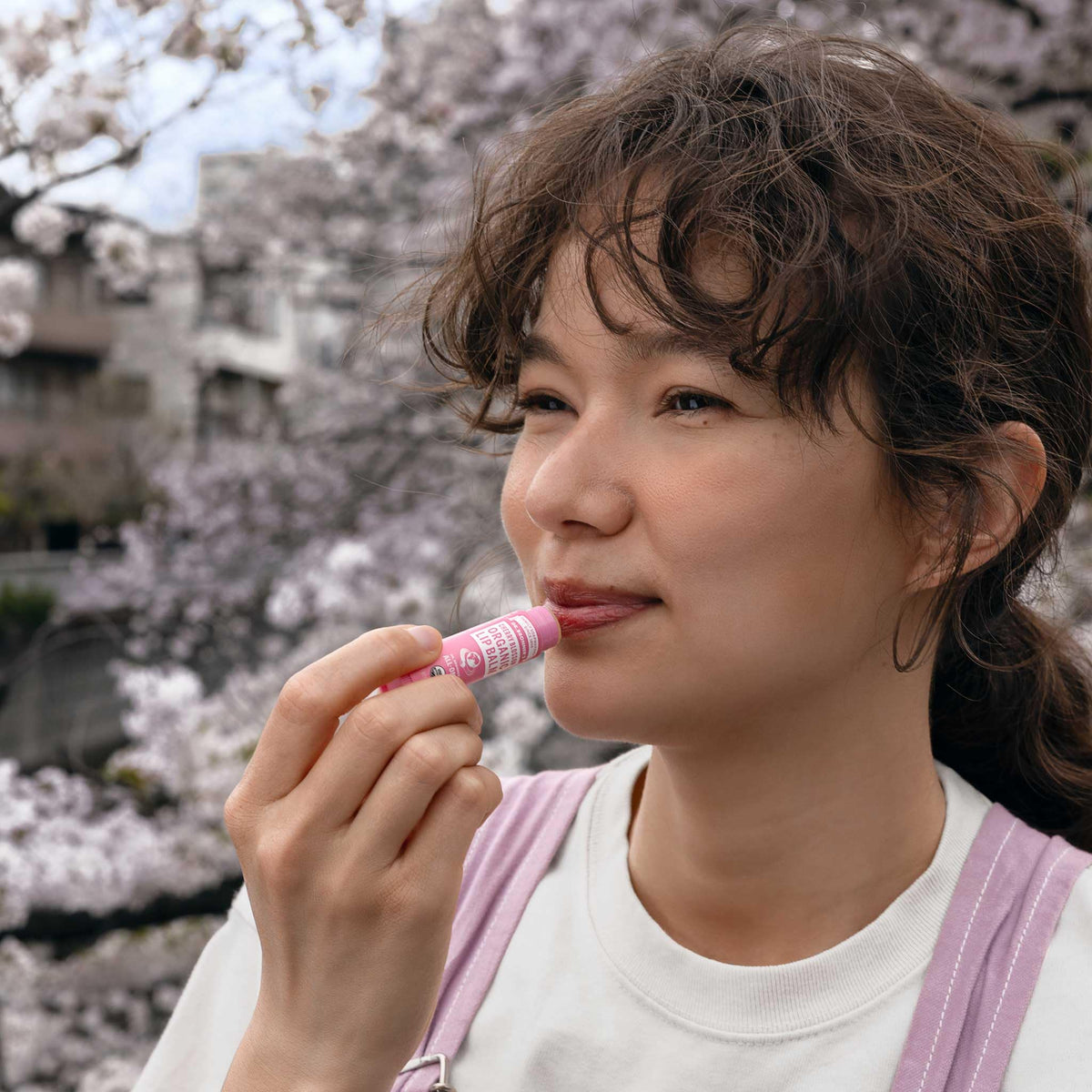 Dr. Bronner's balm applied to lips demonstrating hydration and natural finish