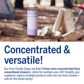 Dr. Bronner's bottle held in hand showing 8 oz size for travel-friendly use