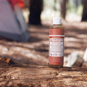 Dr. Bronner's citrus bottle with pump in hand demonstrating easy dispensing