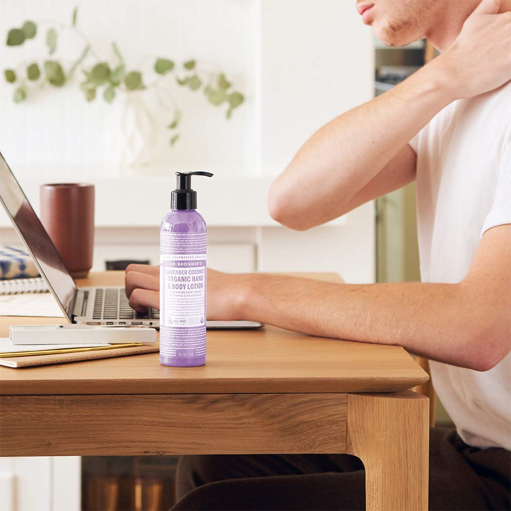 Hand holding Dr. Bronner's peppermint bottle showing cooling, refreshing feel