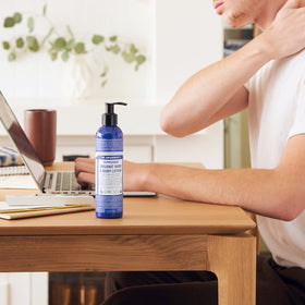 Dr. Bronner's lotion being applied to hands for instant hydration