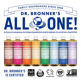 Dr. Bronner's travel-sized bottles next to a coin for size and convenience clarity