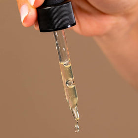 Dr. Dennis Gross serum on a bathroom counter illustrating daily routine compatibility