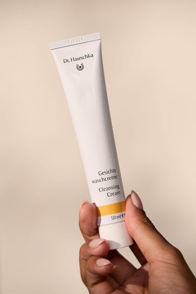 Dr. Hauschka cleansing cream on bathroom counter in routine setting promoting daily skincare habit