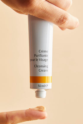 Dr. Hauschka tube held in hand illustrating 1.7 fl oz pocket-friendly size and travel convenience