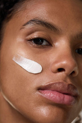 Dr. Hauschka mask being smoothed onto cheek demonstrating easy application and calming effect