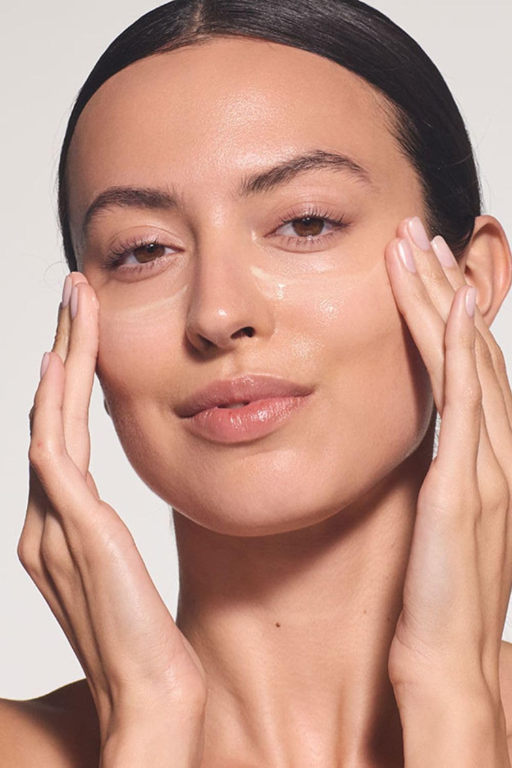 Dr. Hauschka bottle in hand demonstrating 1.7 fl oz travel-friendly size