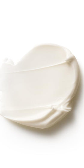 Dr. Hauschka applying cream on hand to demonstrate quick absorption benefit