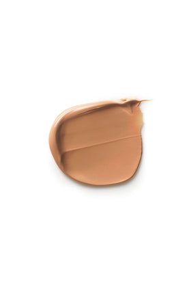 Dr. Hauschka applying tinted cream on cheek for natural even coverage benefit