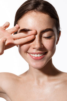 Dr Joe Lab bottle beside creams showing blendable skincare use