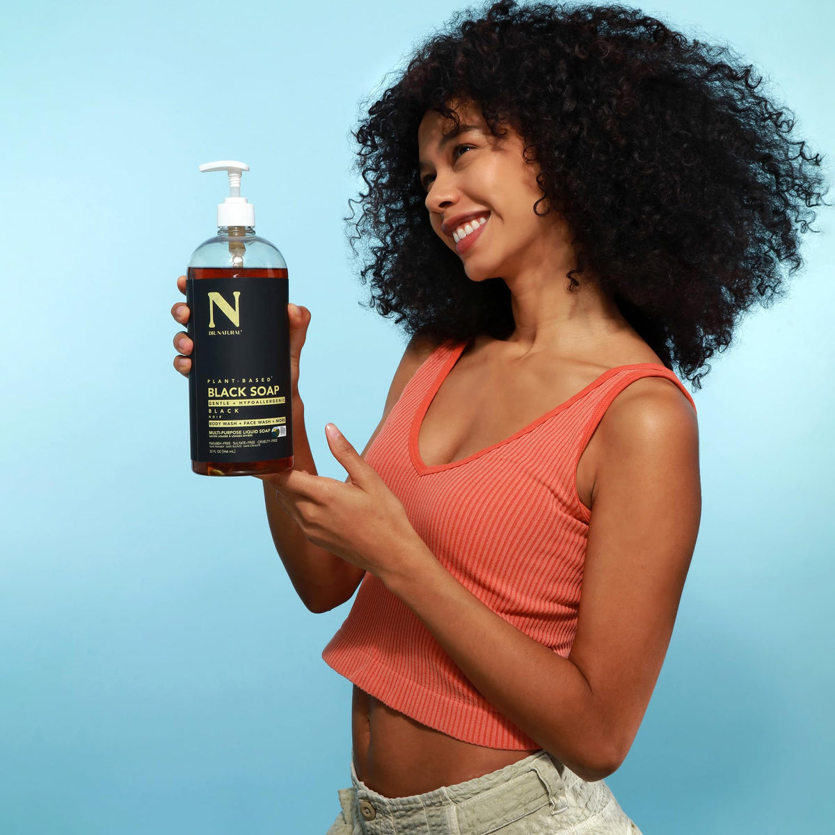 Dr. Natural held in hand to show 32 oz scale and portability