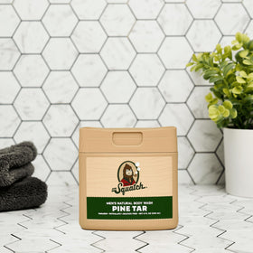 Dr. Squatch Pine Tar bottles staged in shower scene evoking woodsy scent benefit