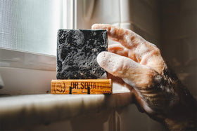 Dr. Squatch bar held in hand showing actual size for portion and value benefit