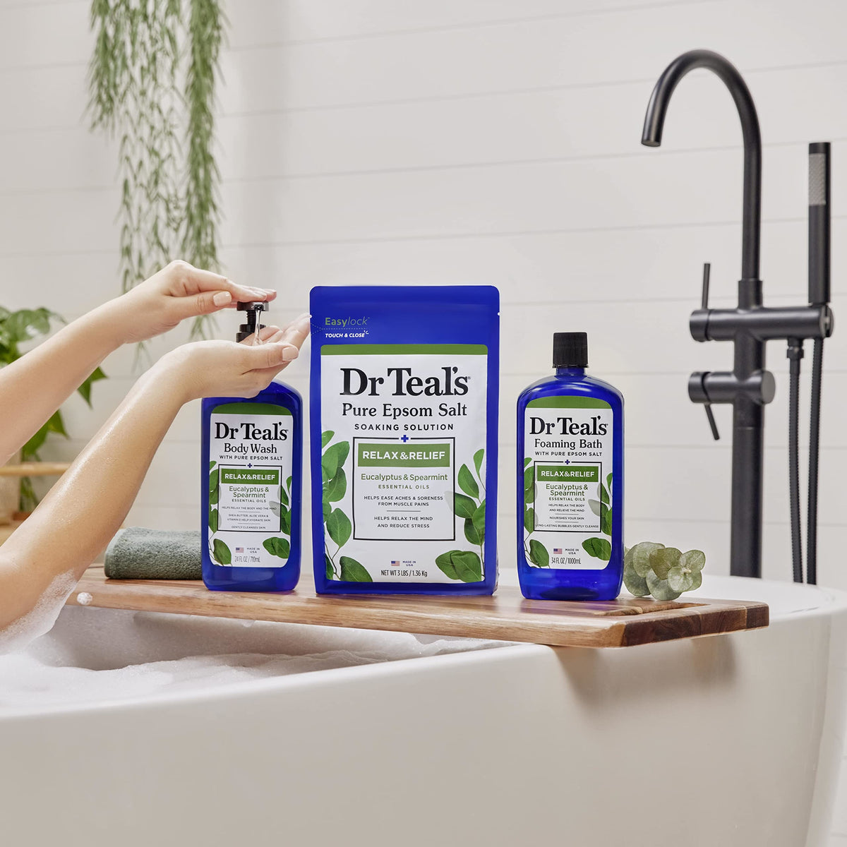 Dr Teal's bottle in shower held during use showing invigorating rinse benefit
