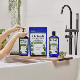 Dr Teal's bottle in shower held during use showing invigorating rinse benefit