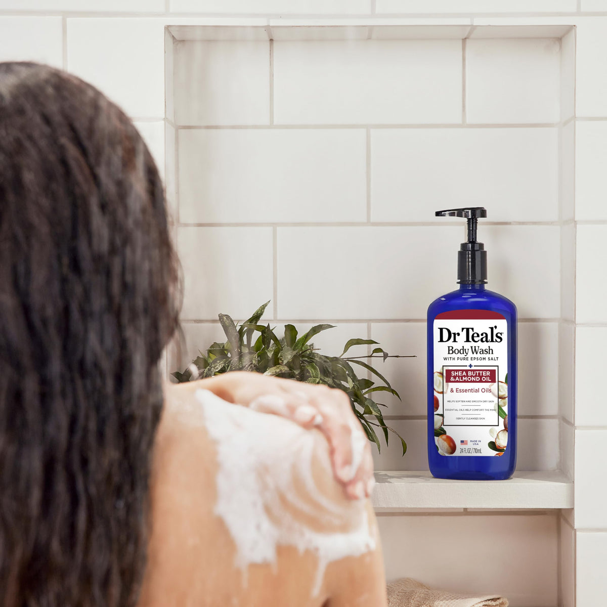 Dr Teal's body wash being poured on loofah to show buildable lather and easy application