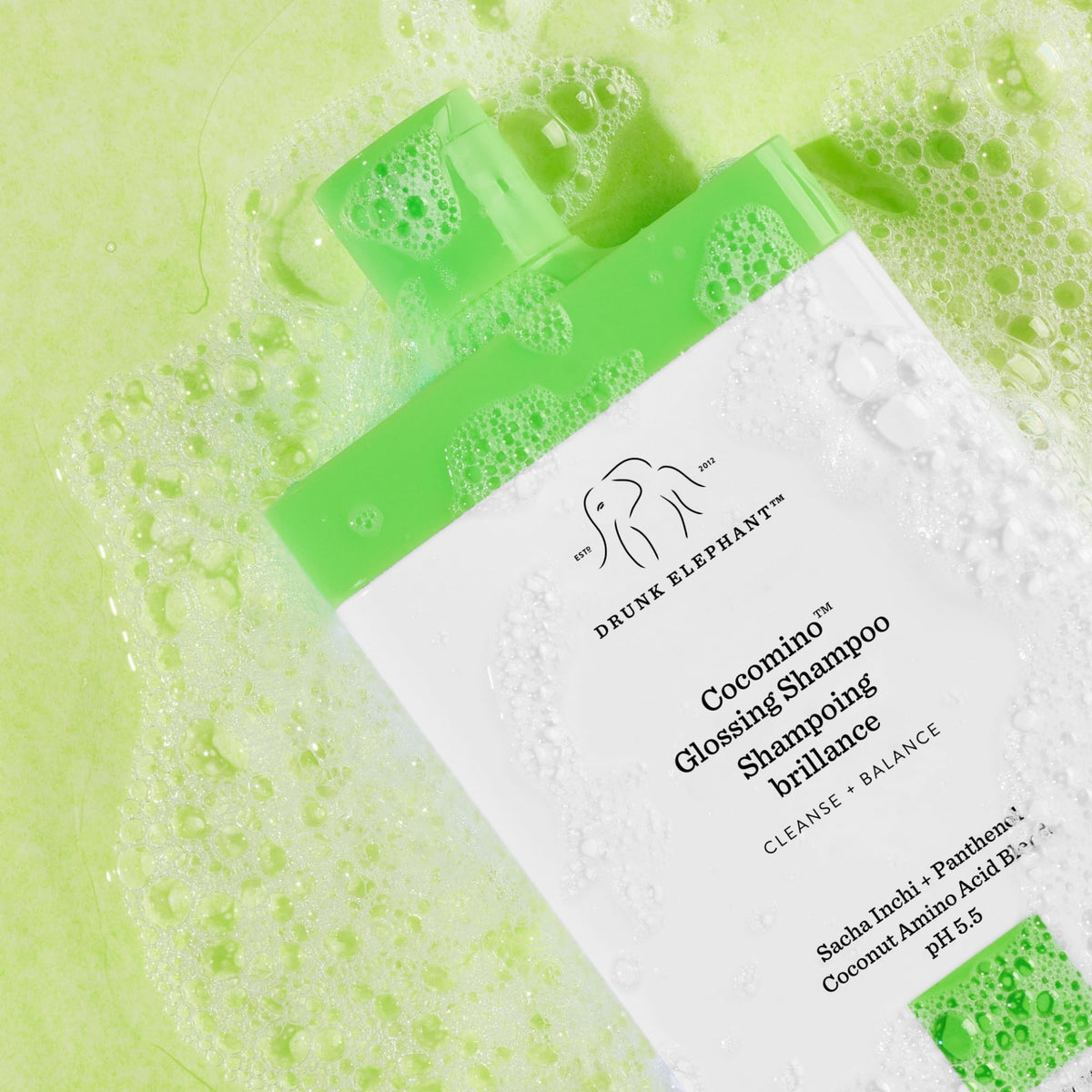Drunk Elephant bottle on bathroom shelf staged for daily haircare routine