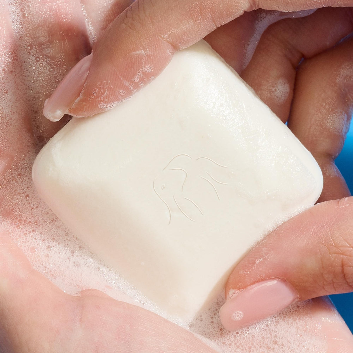 Drunk Elephant Pekee bar lathered in hand demonstrating creamy moisturizing foam