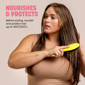 Drybar being sprayed onto damp hair to detangle and prep for styling