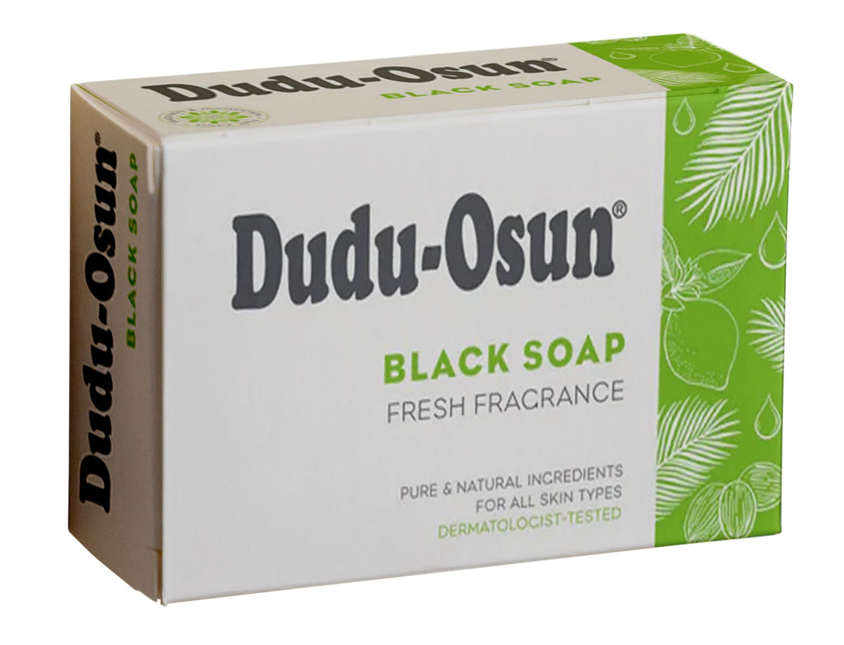 Hand holding Dudu-Osun bar creating foam to demonstrate gentle effective cleansing