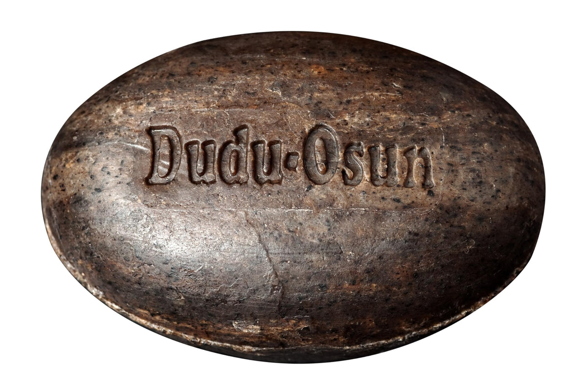 Dudu-Osun bars on bathroom shelf in a tidy setting suggesting daily natural care