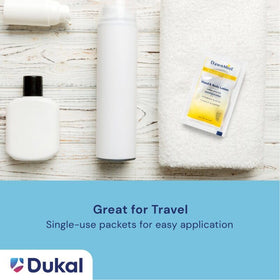 Open Dukal packet being applied to skin showing single-use sanitary benefit