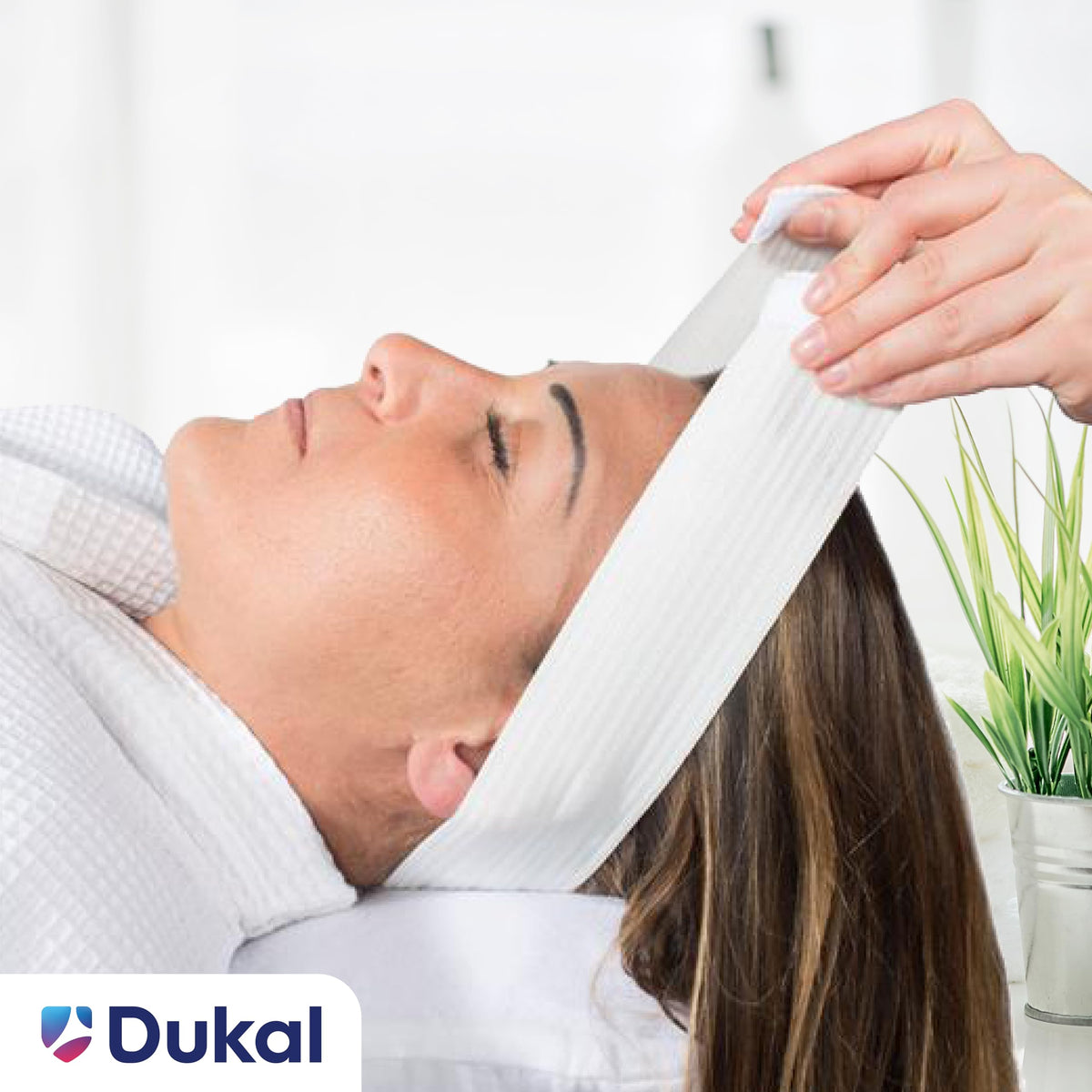 Dukal headband worn during facial treatment keeping hair away cleanly