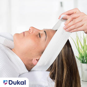 Dukal headband worn during facial treatment keeping hair away cleanly