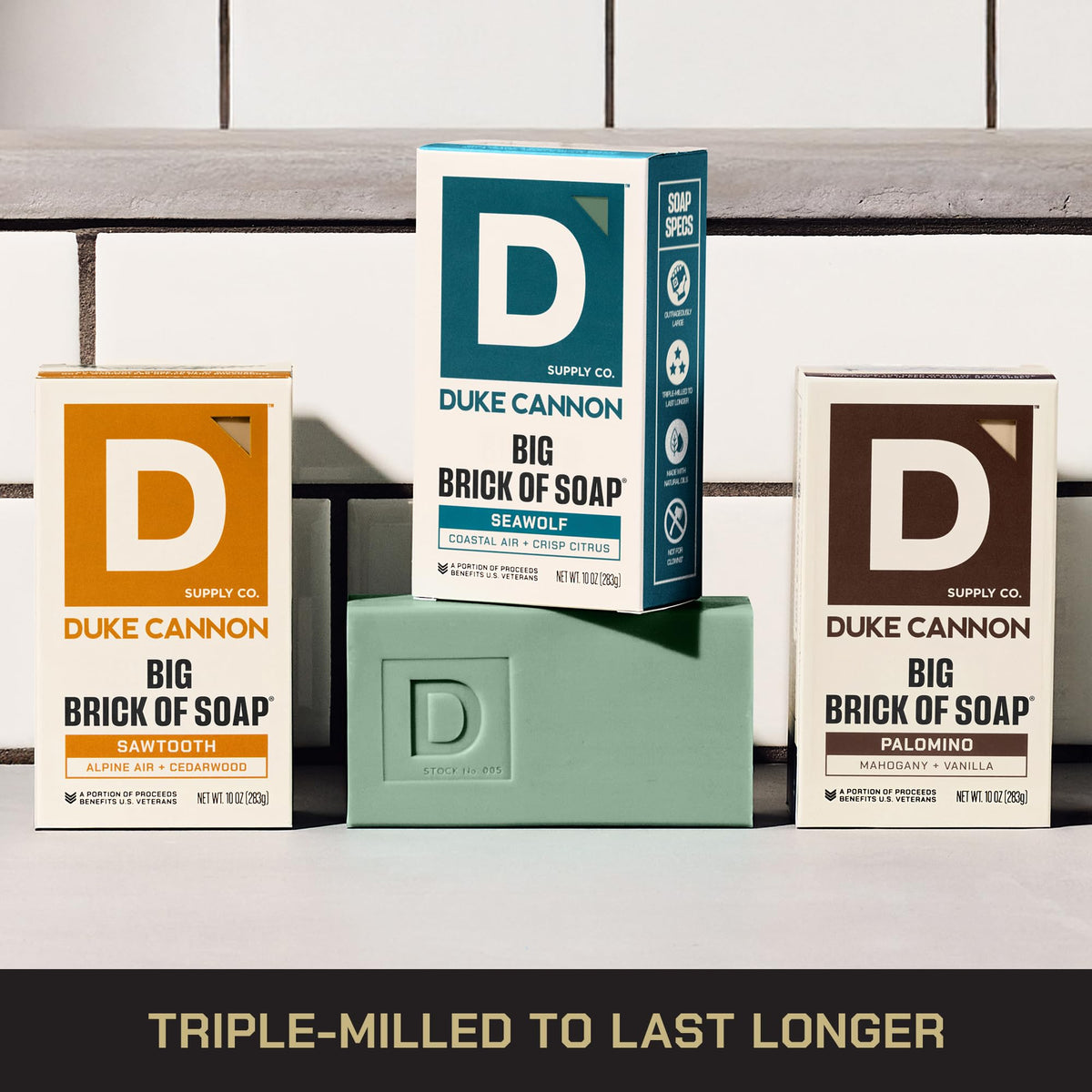 Duke Cannon bars next to a hand showing scale and benefit of oversized 10 oz bricks