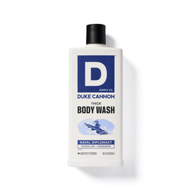 Duke Cannon bottle next to hand for scale, communicates generous 17.5 oz size