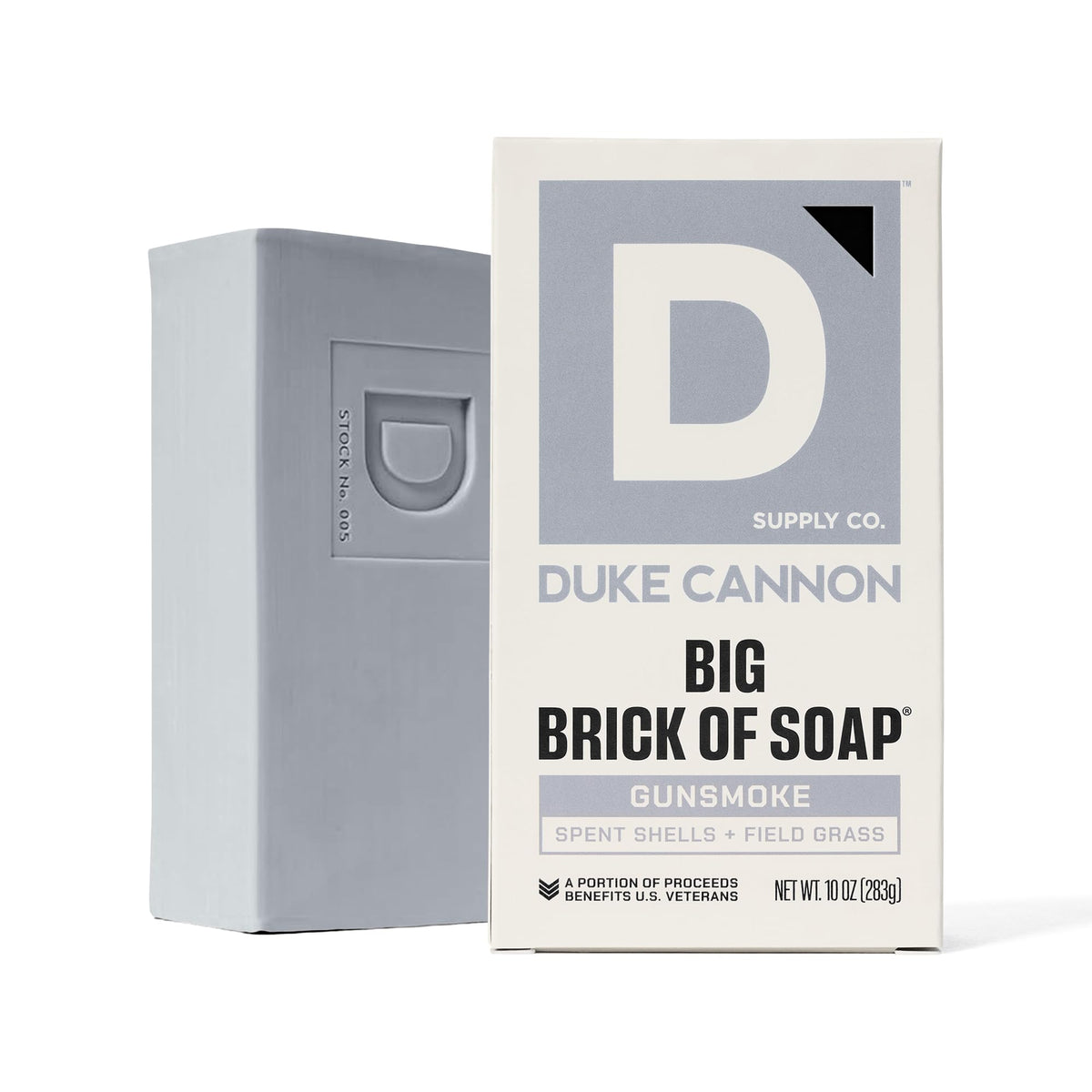 Duke Cannon bar staged by campfire evoking wood and leather scent benefit