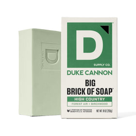 Duke Cannon High Country size comparison in hand demonstrating 10 oz. scale