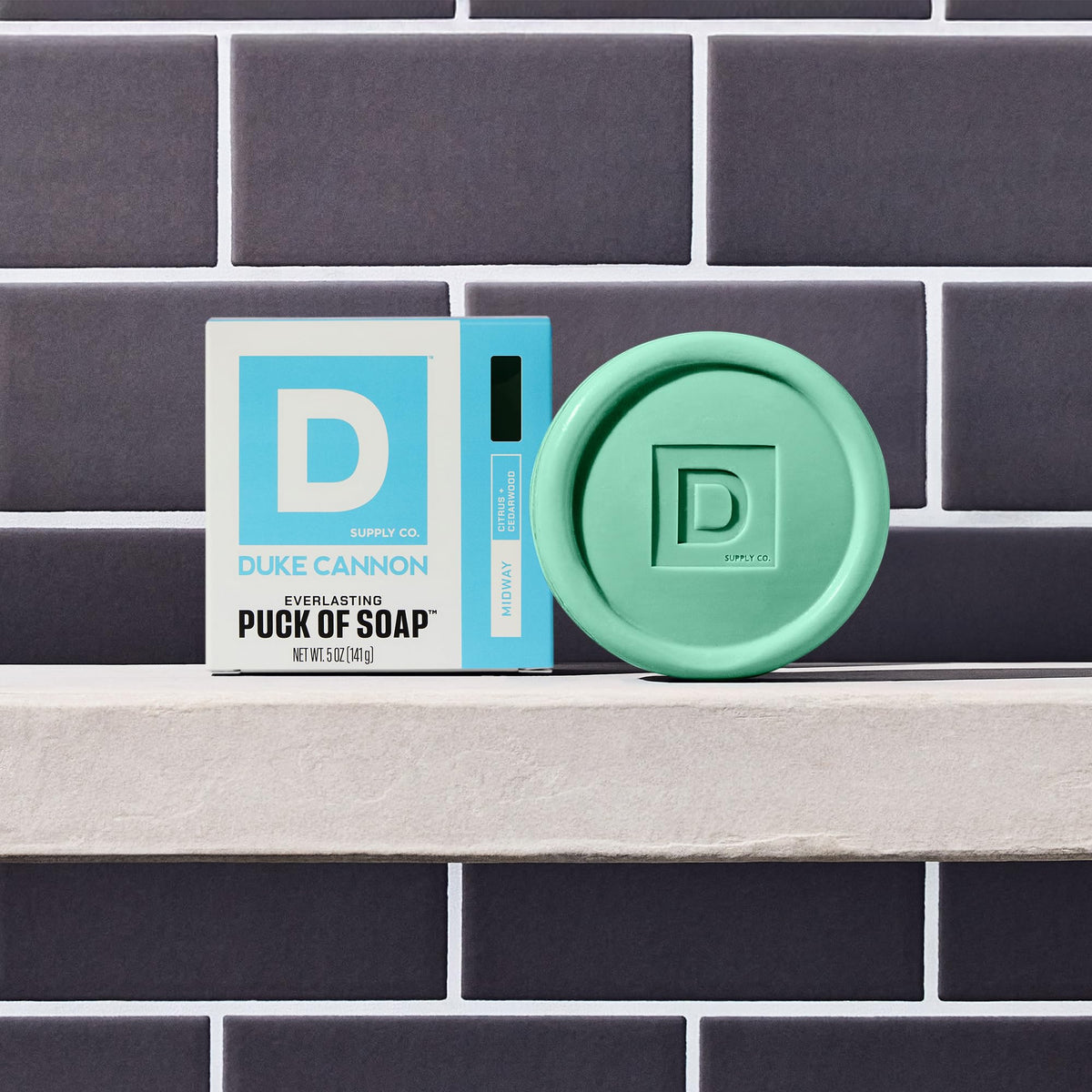 Duke Cannon soap pucks arranged on bathroom vanity suggesting rugged, everyday grooming