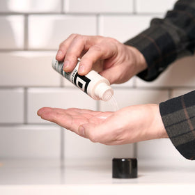 Man styling short hair with product, Duke Cannon delivering natural texture and control