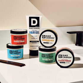 Duke Cannon pomade on bathroom shelf suggesting grooming routine
