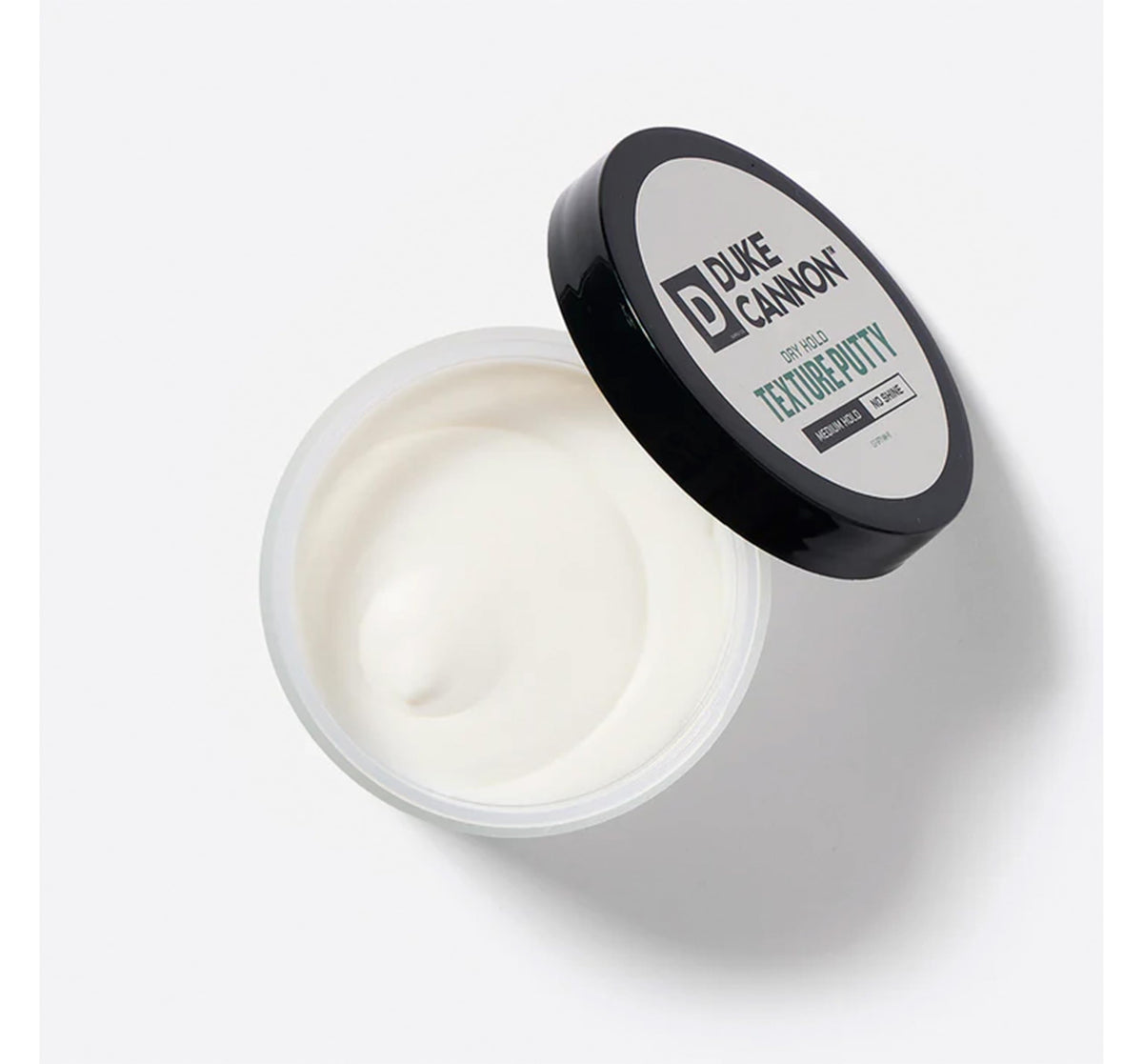 Duke Cannon hands applying putty demonstrating smooth spreadability and precise control