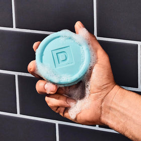 Duke Cannon soap puck next to a ruler to show 5 oz size and travel-friendly scale