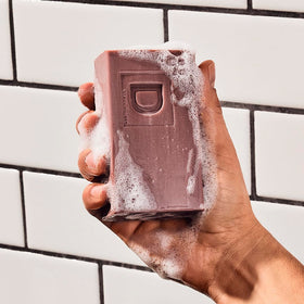 Duke Cannon soap in use under shower illustrating effective daily cleansing