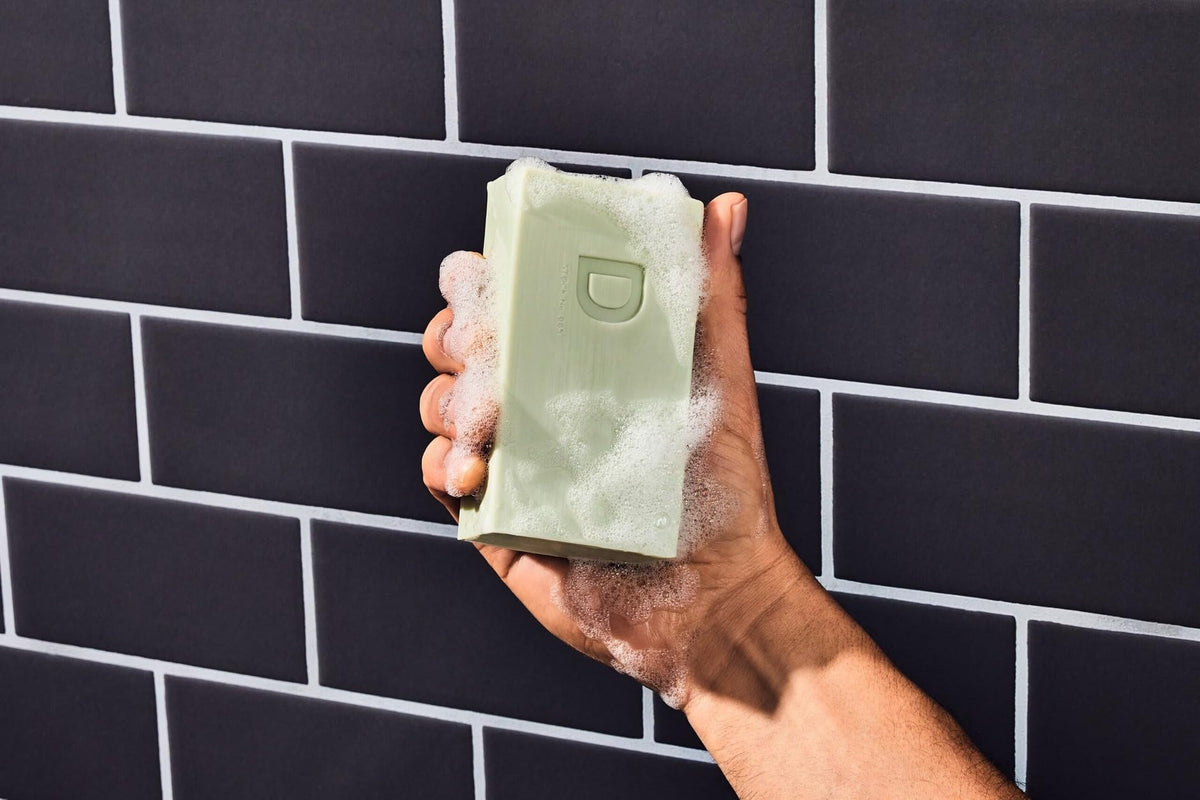 Duke Cannon soap producing rich lather in shower demonstrating effective cleansing