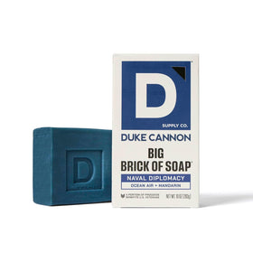 Duke Cannon Tactical soap on a rope pouch hung by a shower hook for convenient access