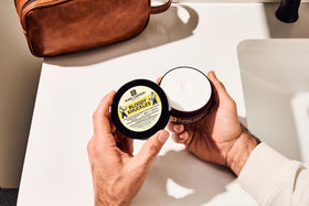 Duke Cannon tin on a workbench illustrating protection for hardworking hands