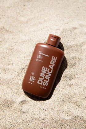 DUNE Golden Guard in a beach bag being used outdoors showing reef-safe benefit