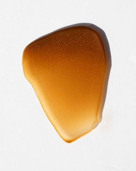 DUNE Golden Guard lotion texture close-up highlighting quick-absorbing finish