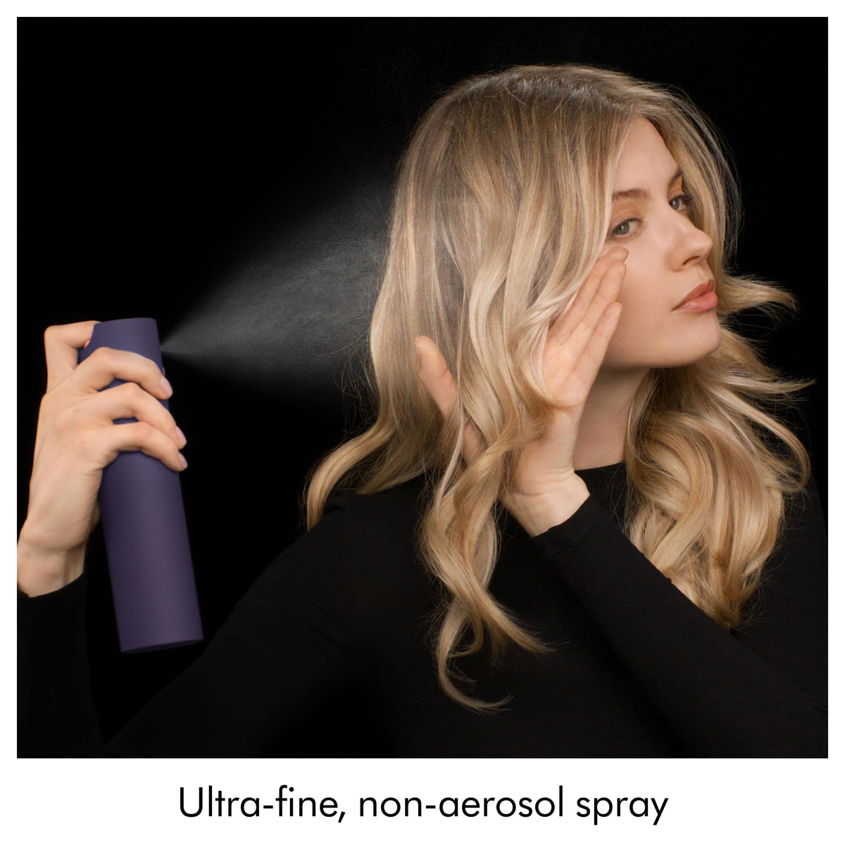 Applying Dyson Chitosan to curly hair to refresh and define natural bounce