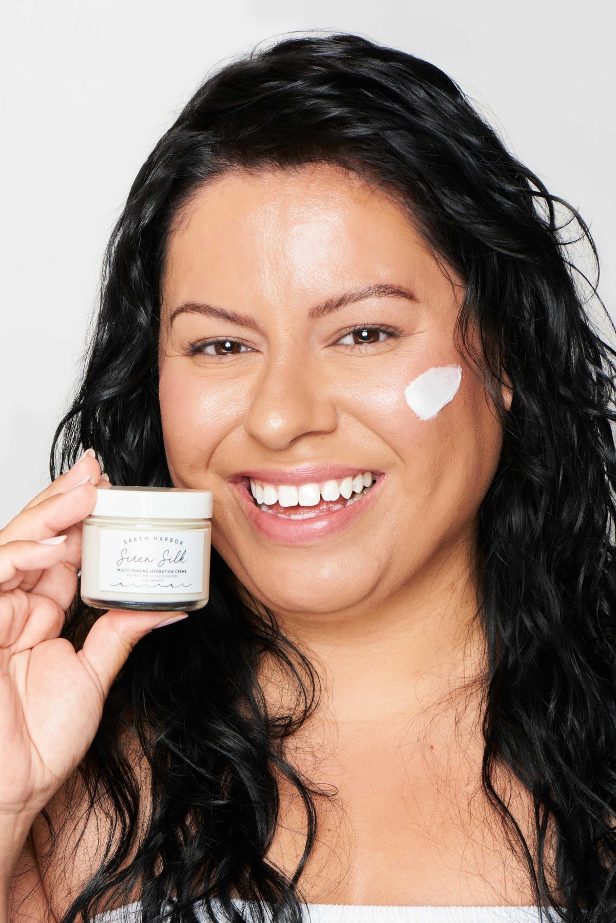 Earth Harbor applying cream to hand demonstrating smooth spreadability