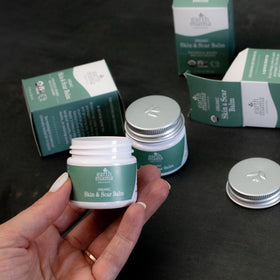 Earth Mama two tins inside travel bag for on-the-go skin support