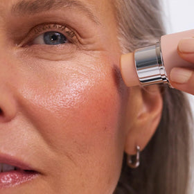EarthsCure highlighter applied to cheekbone, shows blended luminous finish for photos