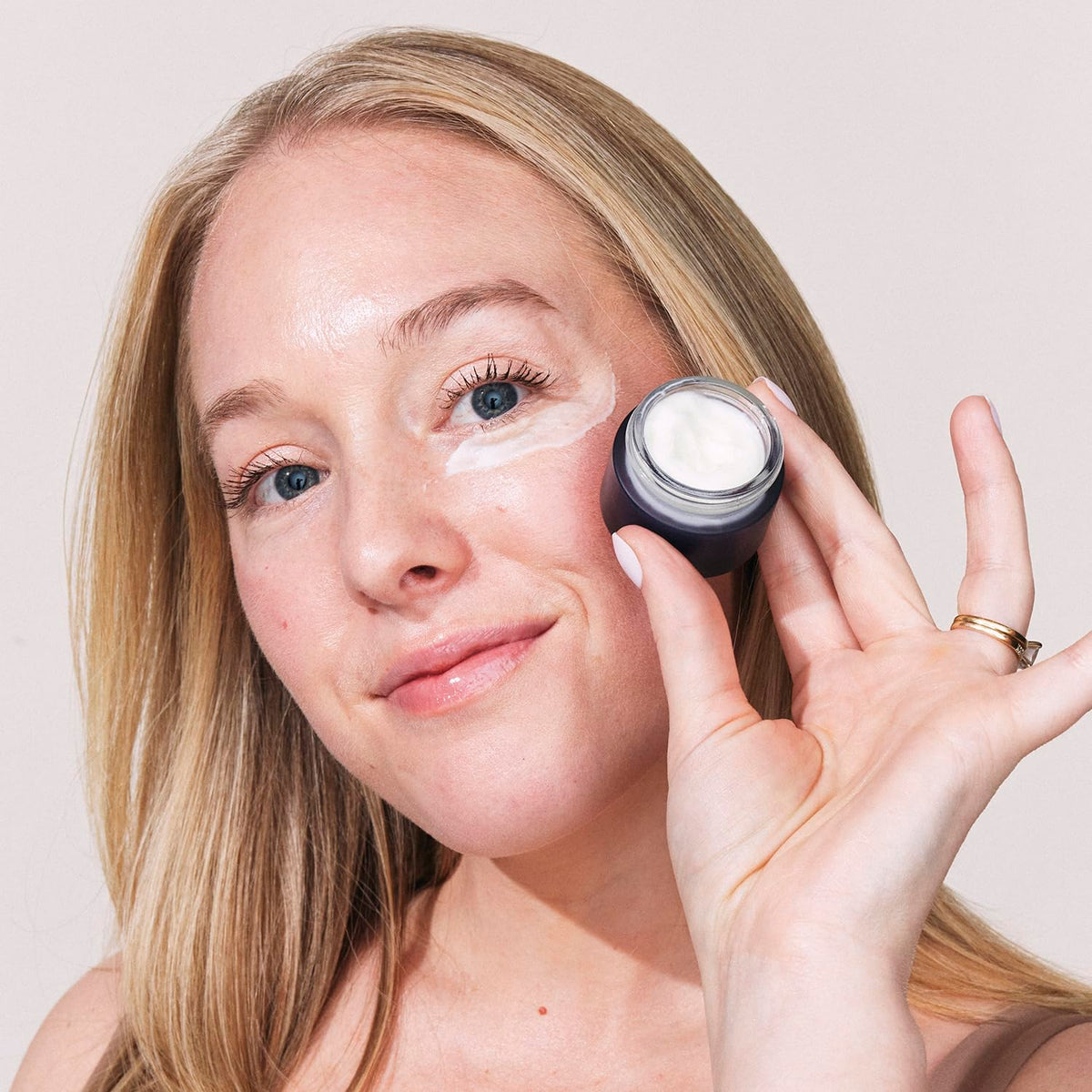 Eight Saints cream being applied to fingertip demonstrating easy application benefits