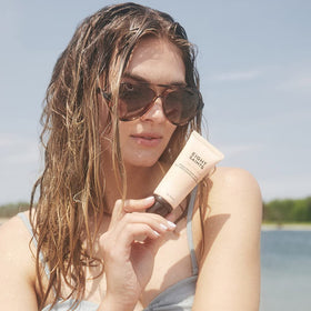 Eight Saints tube held in hand for scale, compact 2 ounce travel-friendly sunscreen