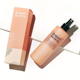 Eight Saints lotion spraying from bottle into hand demonstrating easy, even application